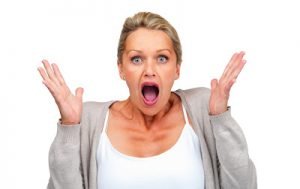 Surprised woman isolated against white background